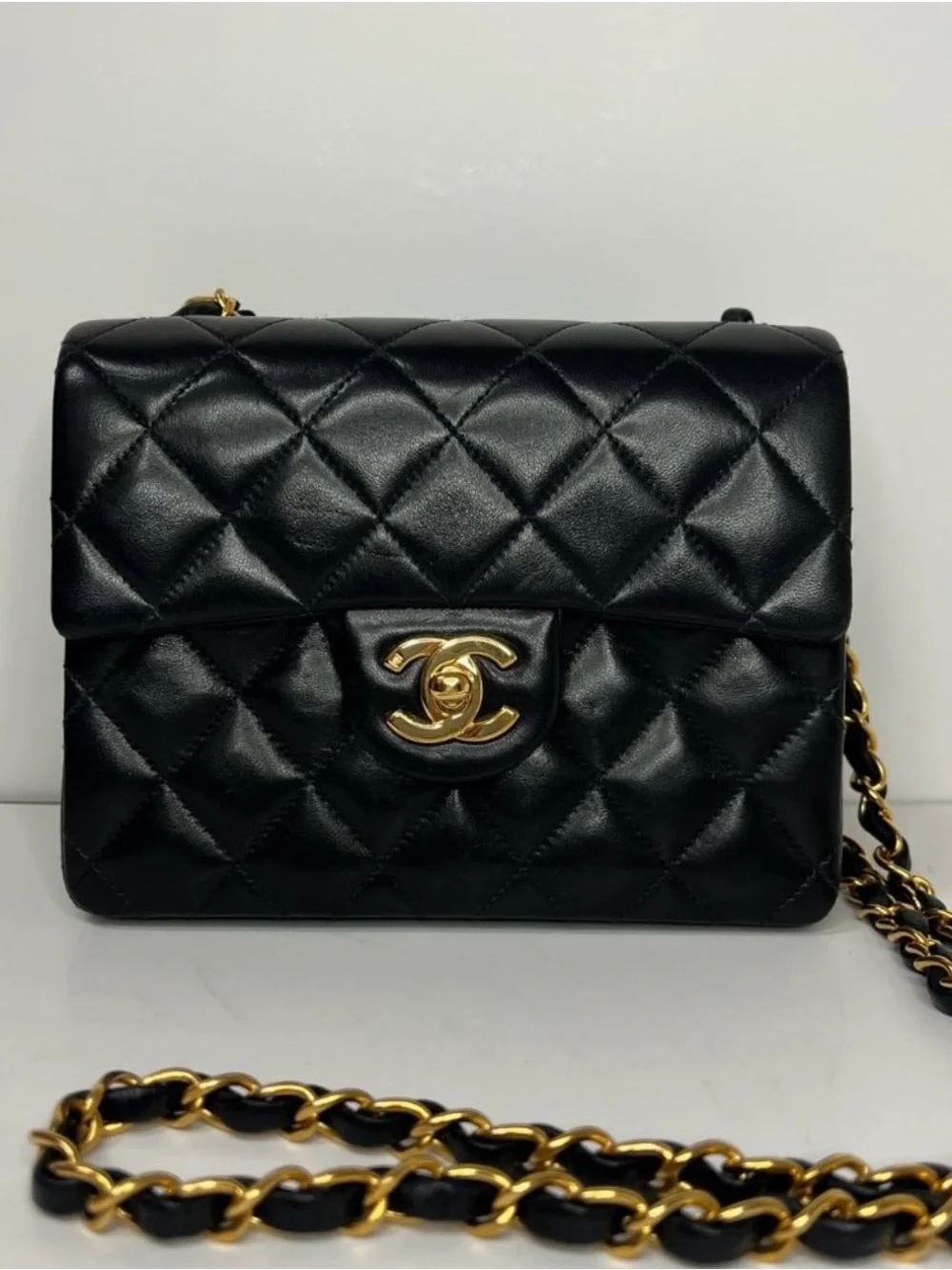 CHANEL Black Quilted Leather Mini Flap Bag with Gold Chain